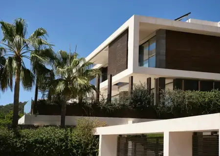 White tropical villa framed by palms in Tamarin
